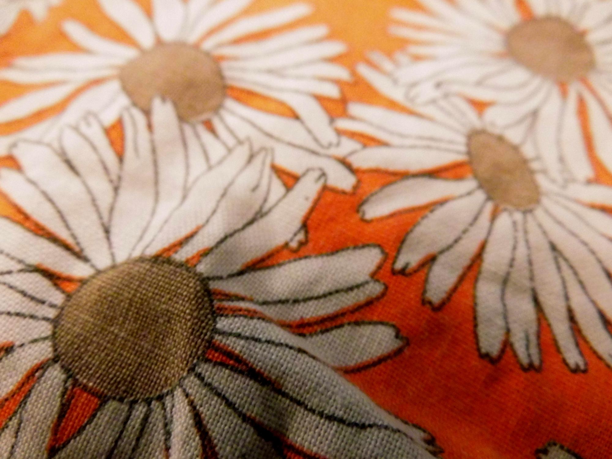 Hand-stitched floral patch on linen